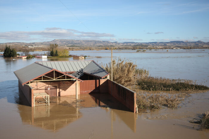 Two dead in floods after river bursts bank